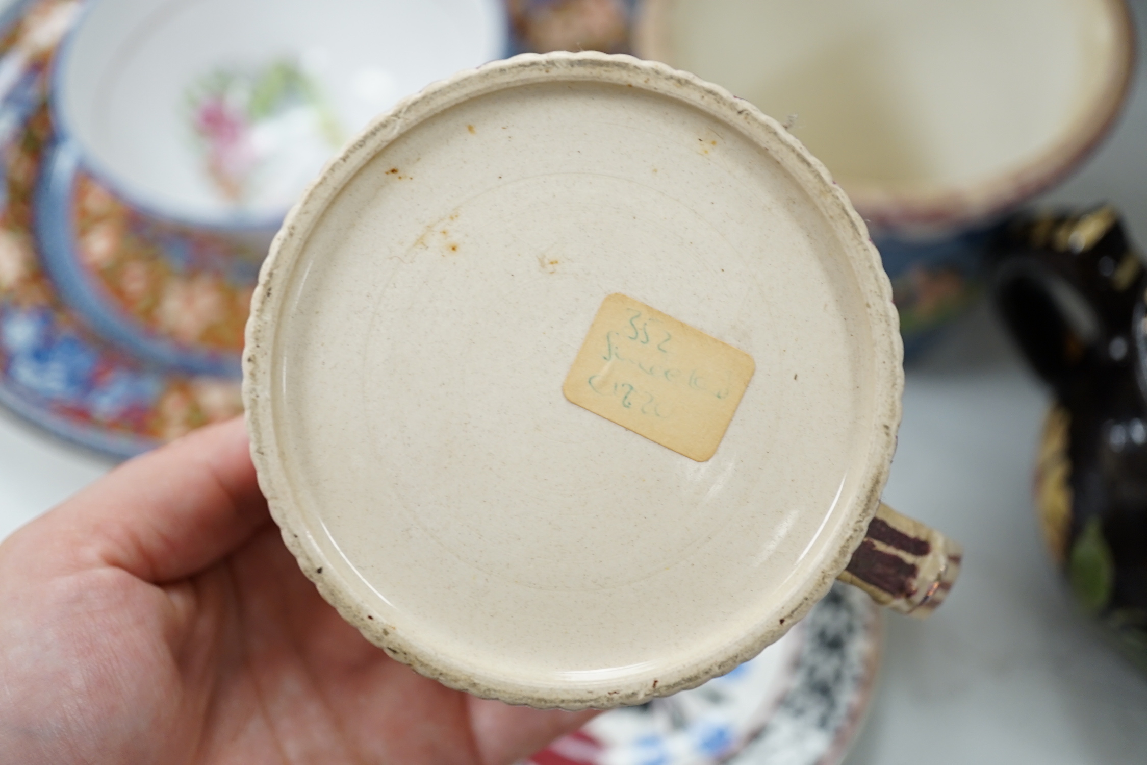 Two Pratt type jugs, an Enoch Wood flower pot, various 19th century pottery jugs, plates etc.